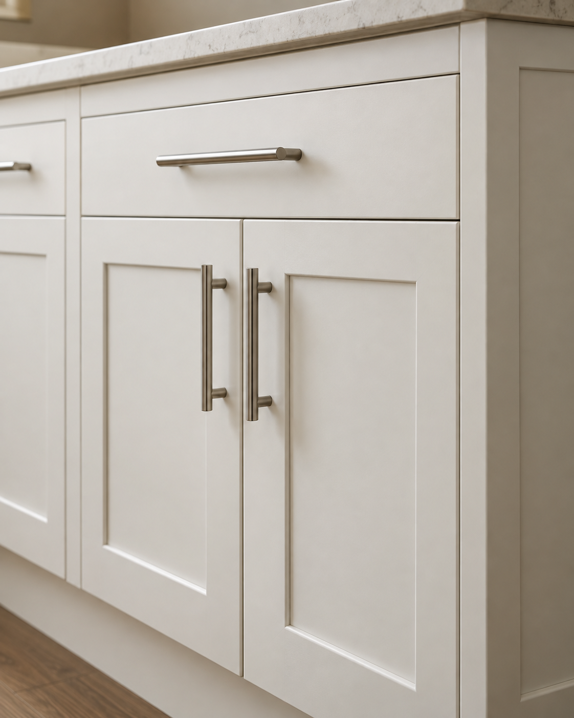 Illustration of warm white shaker cabinet doors with aligned edges and brushed nickel pulls