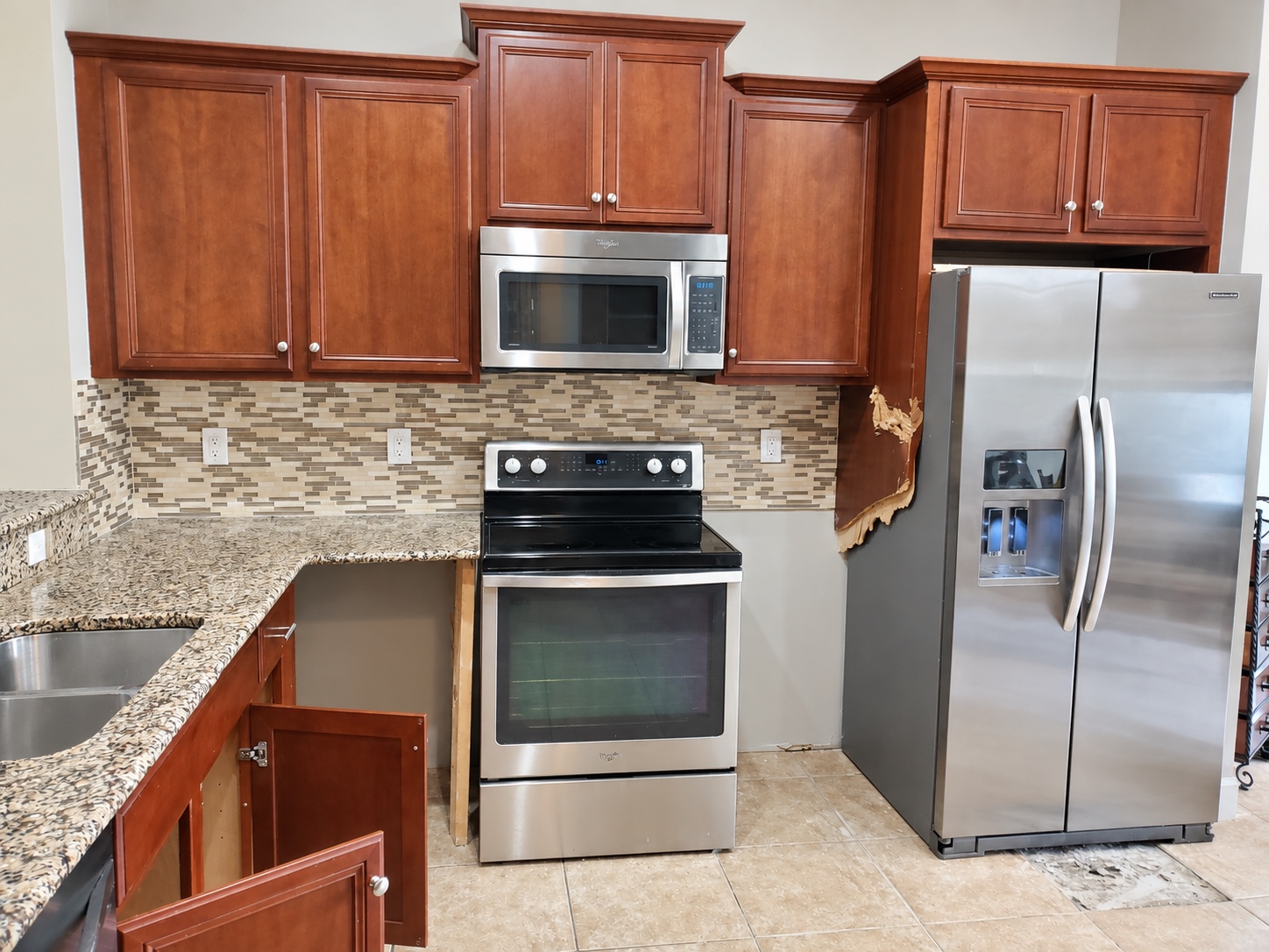 Kitchen before refacing: cherry raised-panel doors and drawer fronts