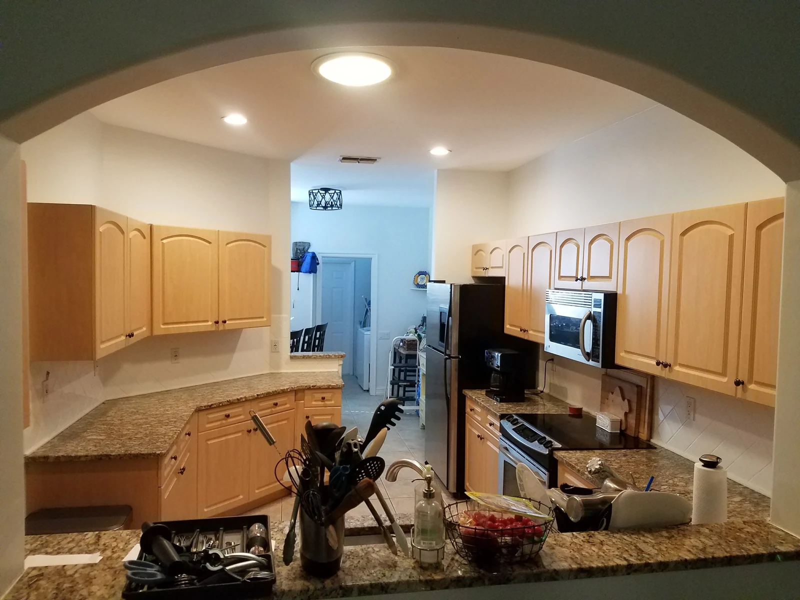 Cabinet view through an arched wall opening before the fronts were updated
