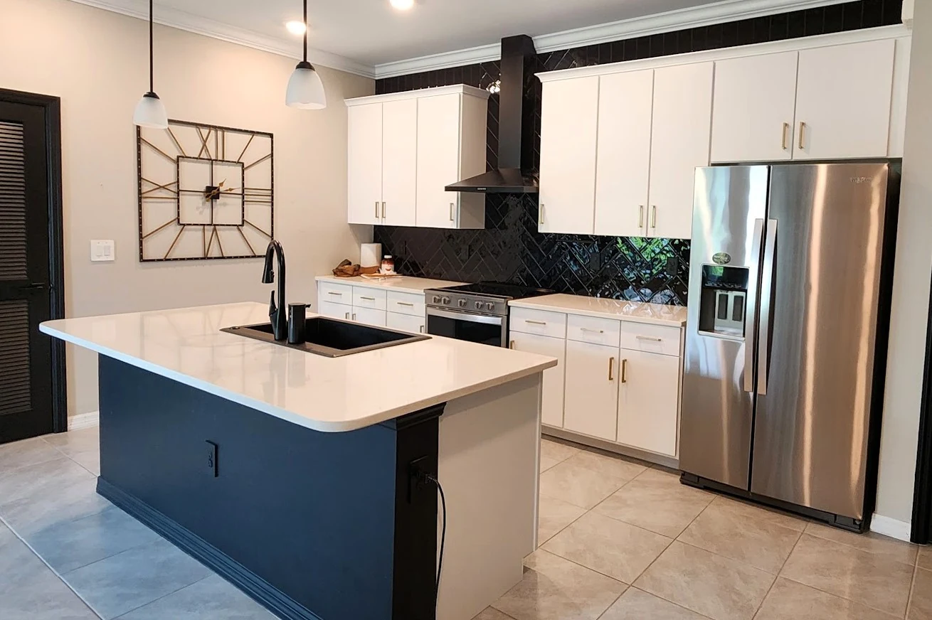 The same kitchen with an updated flat white door style and brass hardware
